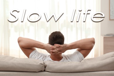 Image of Man resting on sofa at home. Slow life