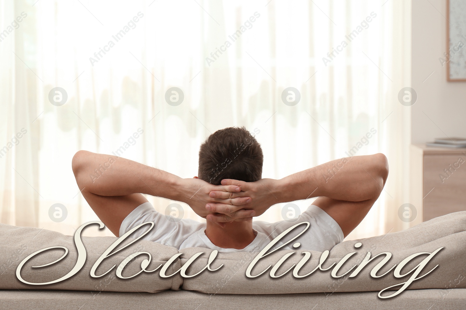 Image of Man resting on sofa at home. Slow living