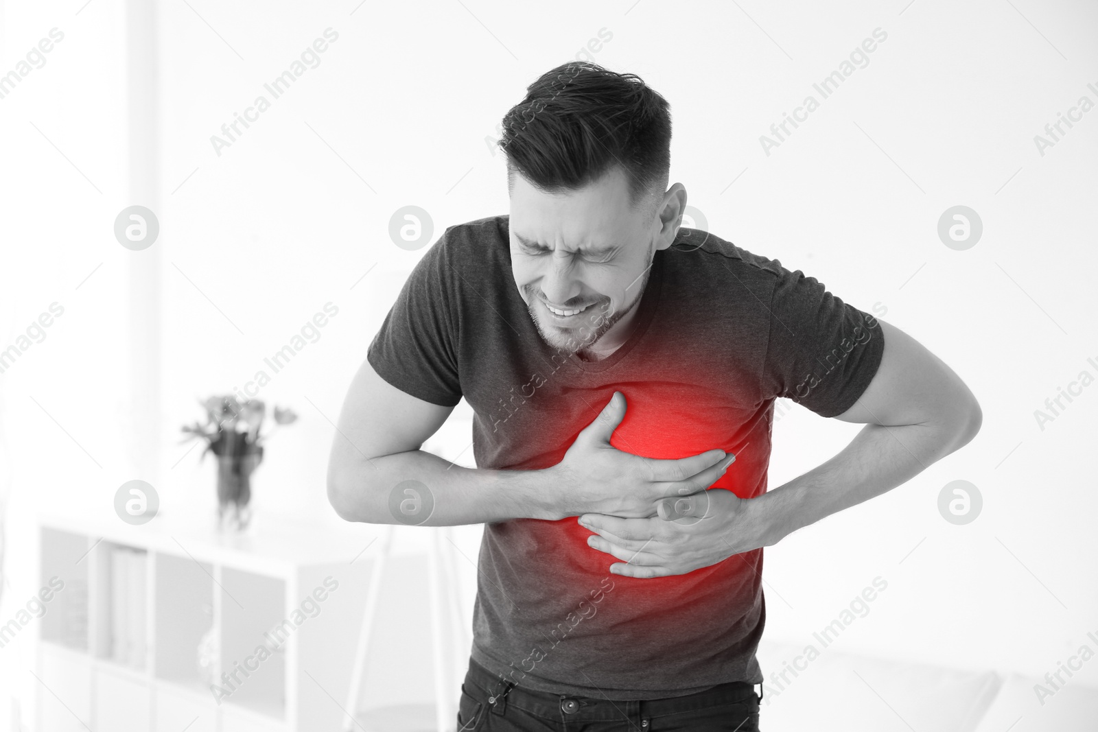 Image of Man suffering from pain in chest at home. Heart disease