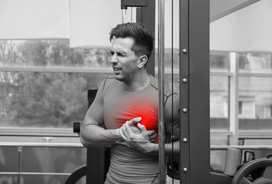 Image of Man suffering from heart pain in gym