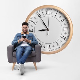 Image of Man with smartphone sitting in armchair near big clock on white background