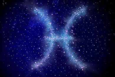 Image of Pisces zodiac sign made of stars on night sky