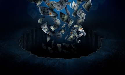 Image of Dollar bills falling into hole. Financial crisis