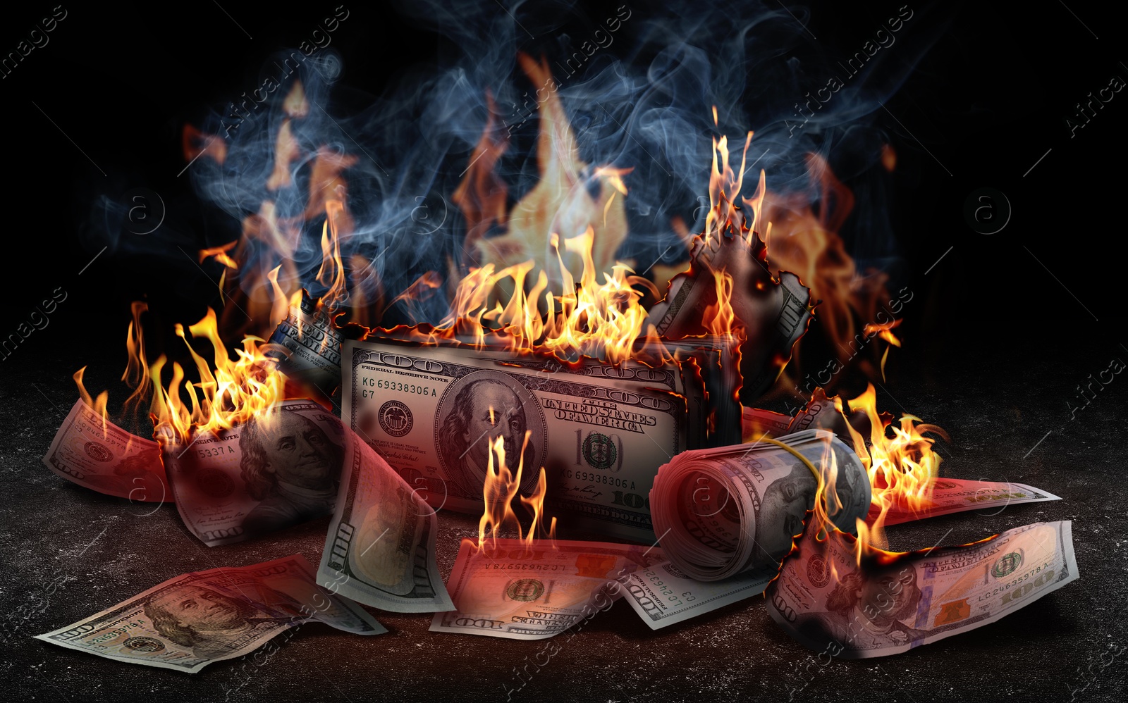 Image of Burning money on black background. Financial crisis