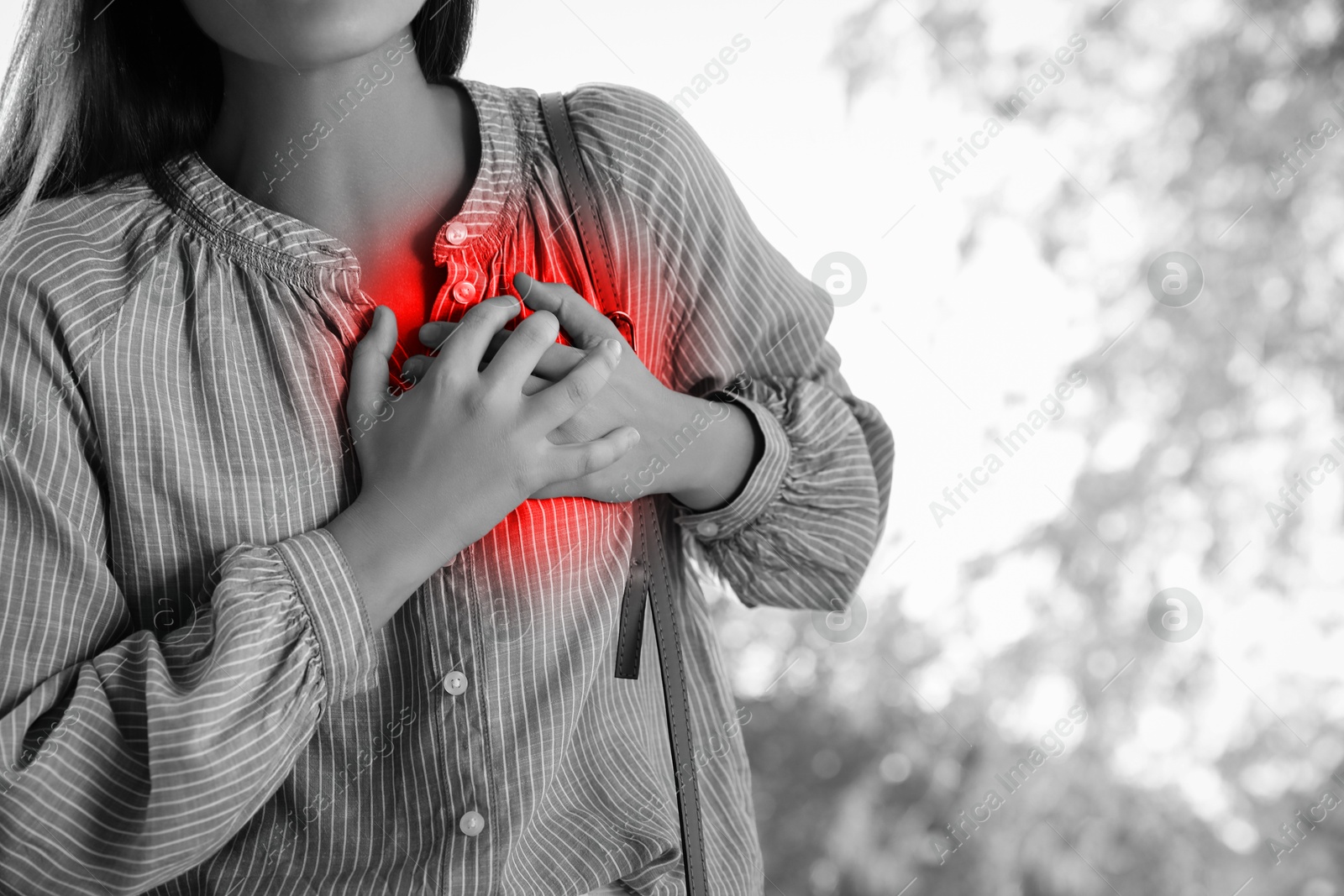 Image of Man suffering from pain in chest outdoors, closeup. Heart disease