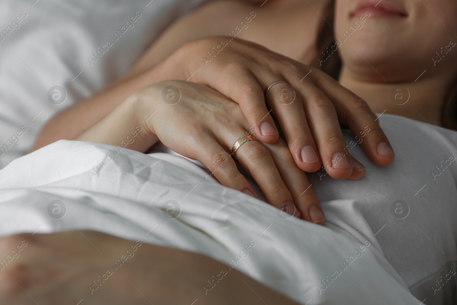 Photo of Lovely couple lying in bed, closeup view