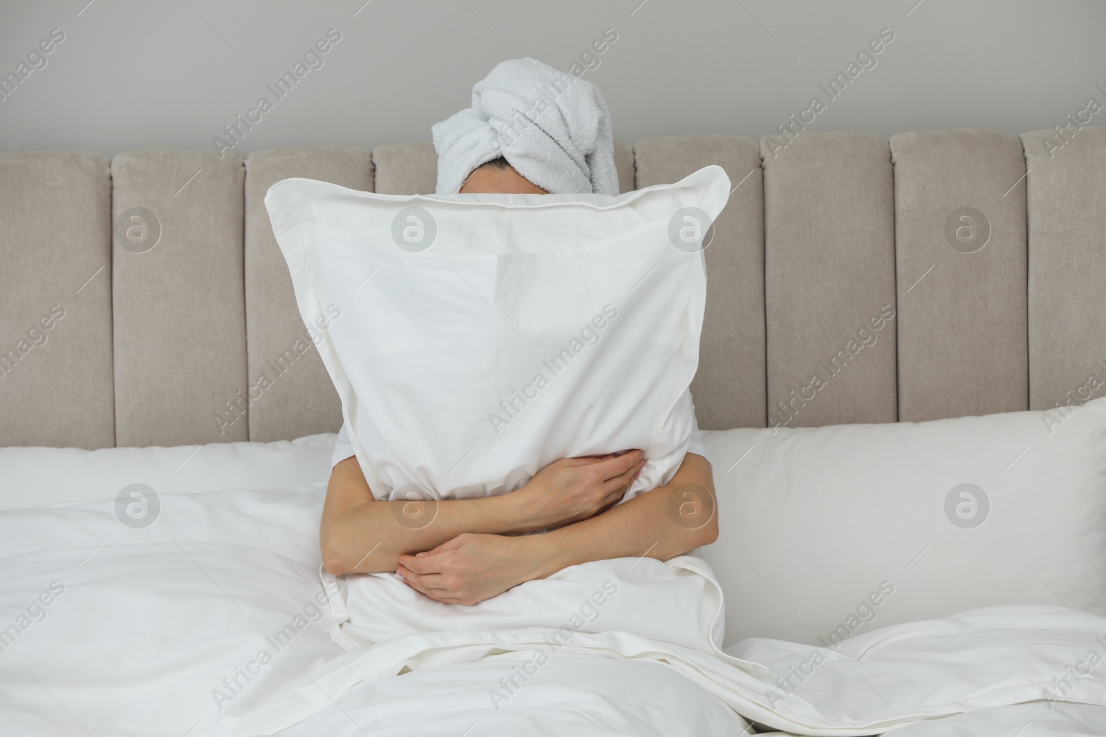 Photo of Woman hugging pillow in bed. Good morning