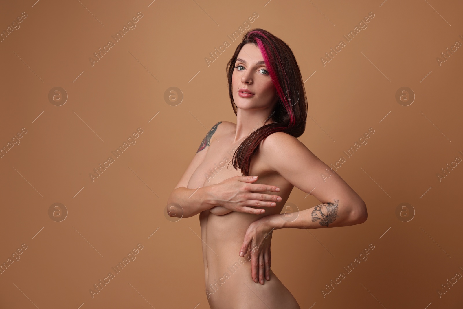 Photo of Sexy nude woman posing on beige background