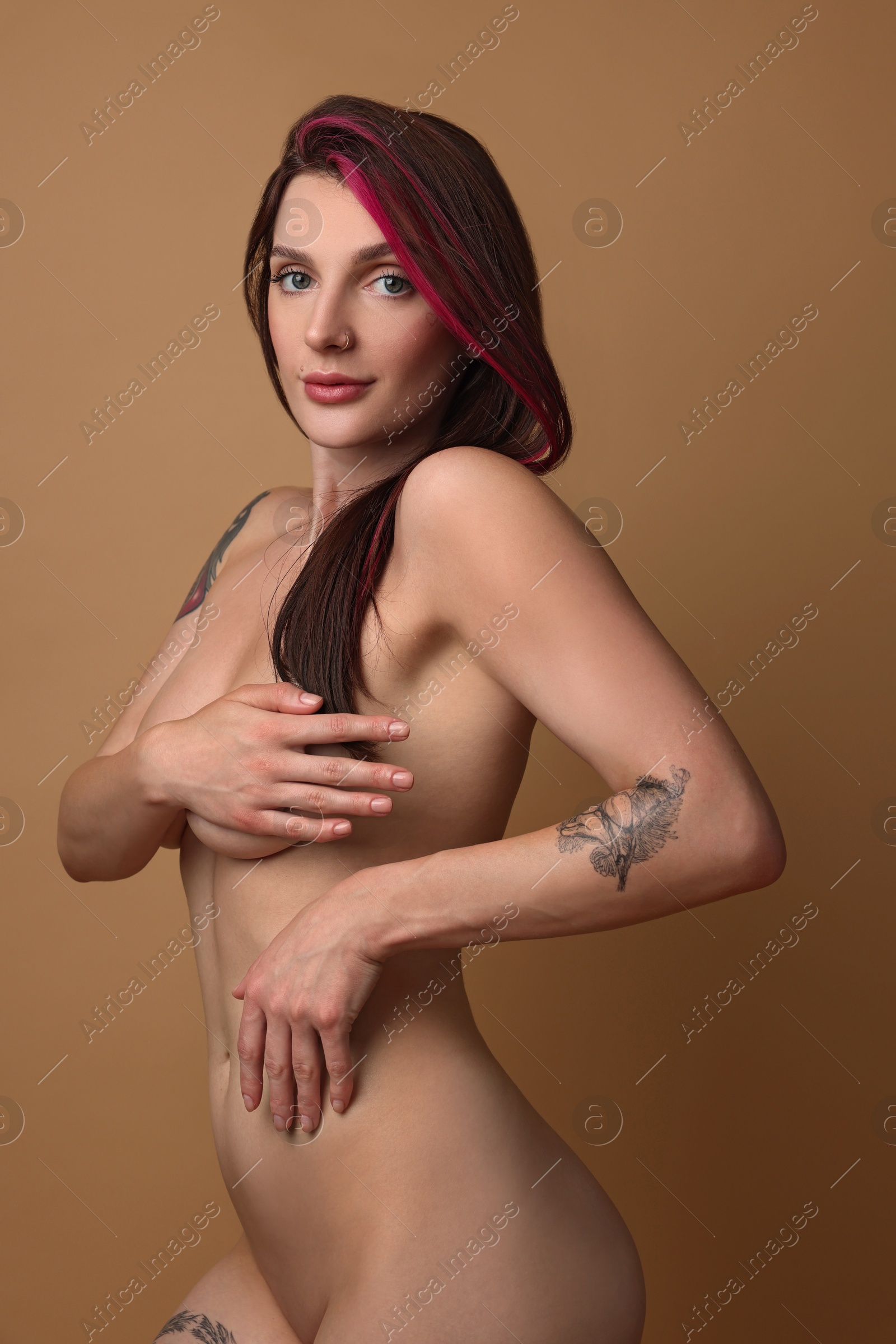 Photo of Sexy nude woman posing on beige background