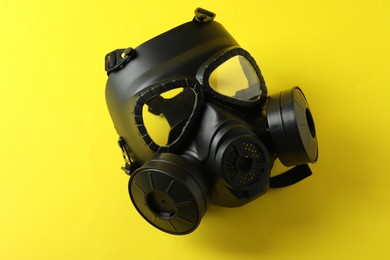 Photo of One gas mask on yellow background. Safety equipment