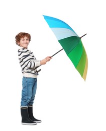 Little boy with rainbow umbrella on white background