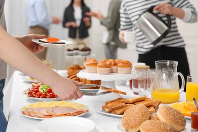 Coworkers having business lunch in restaurant, closeup