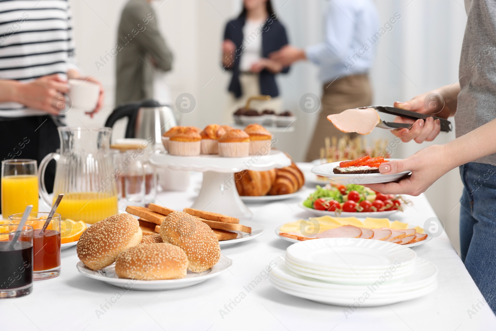 Photo of Coworkers having business lunch in restaurant, closeup