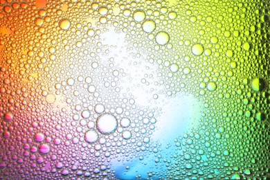 Photo of Essential oil bubbles on color background, top view. Cosmetic product