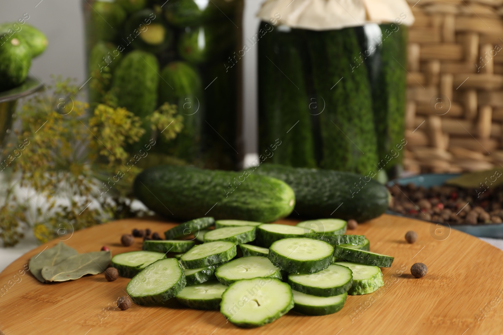 Photo of Board with fresh cucumbers and spices on table, closeup