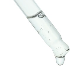 Dripping cosmetic serum from pipette on white background, closeup