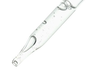 Photo of Dripping cosmetic serum from pipette on white background, closeup