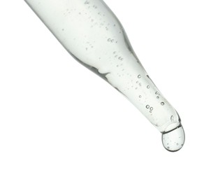 Dripping cosmetic serum from pipette on white background, closeup