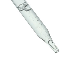 Dripping cosmetic serum from pipette on white background, closeup