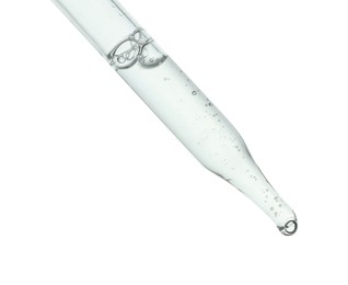 Dripping cosmetic serum from pipette on white background, closeup