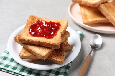 Delicious toasts with jam on light table, closeup