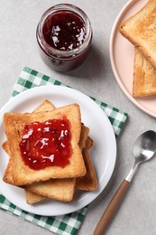 Delicious toasts with jam on light table, flat lay