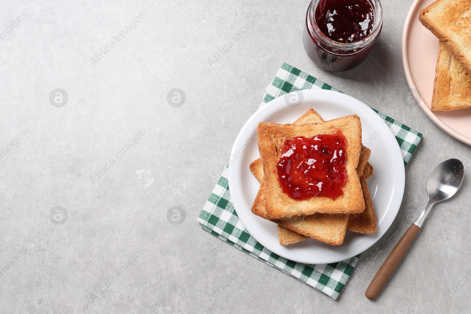 Photo of Delicious toasts with jam on light table, flat lay. Space for text