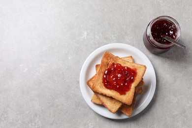 Delicious toasts with jam on light table, top view. Space for text