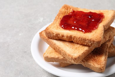 Delicious toasts with jam on light table, closeup