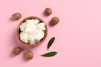 Natural shea butter and nuts on pink background, flat lay. Space for text