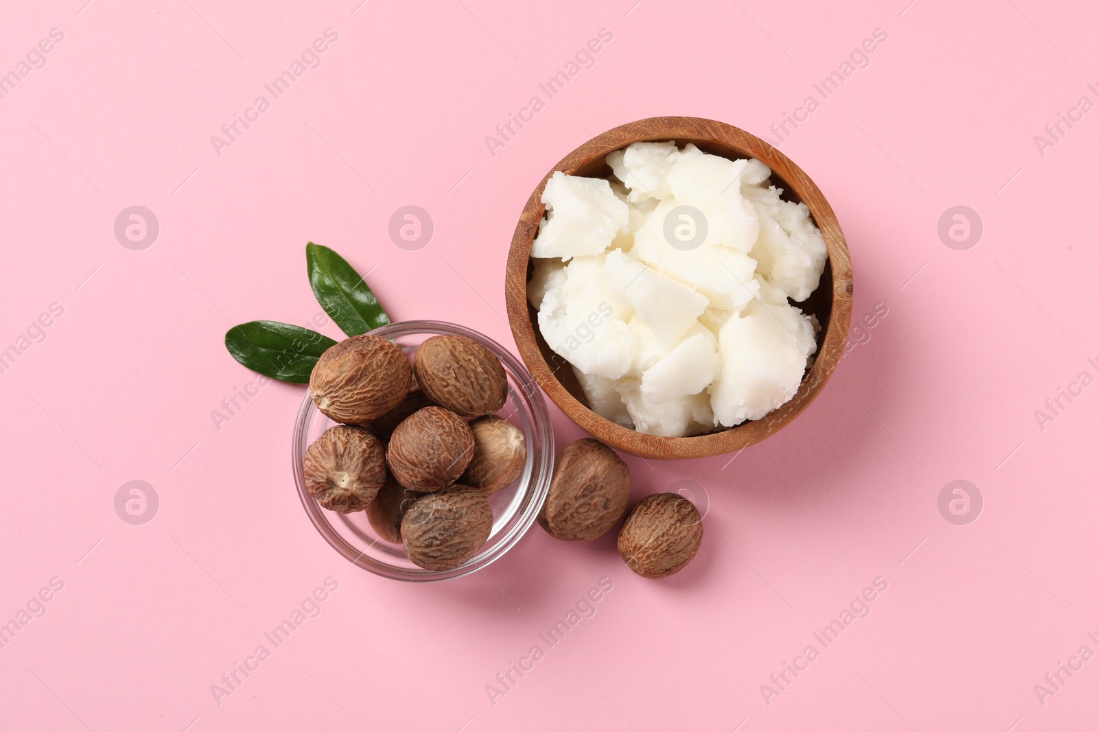 Photo of Natural shea butter and nuts on pink background, flat lay