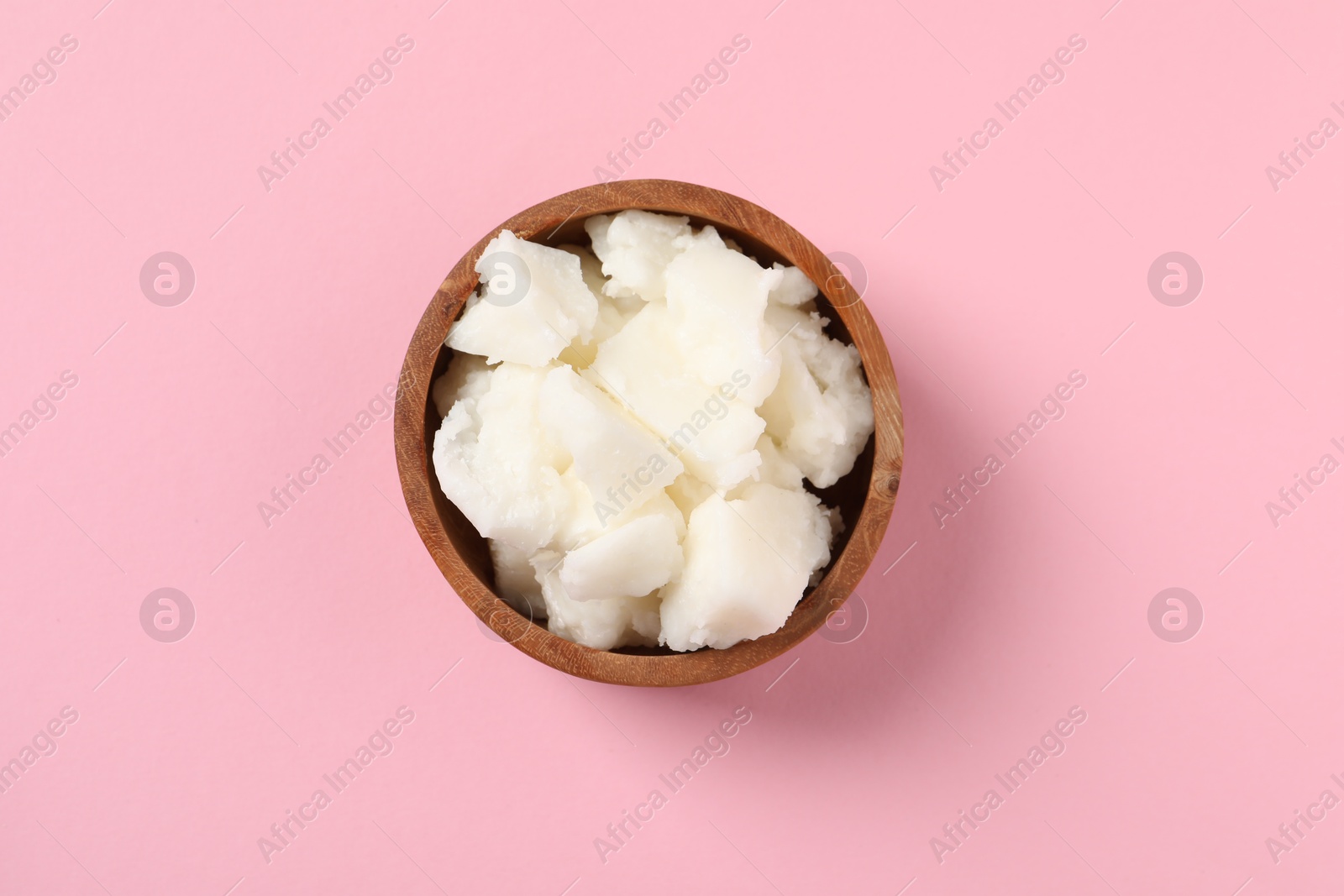 Photo of Natural shea butter on pink background, top view