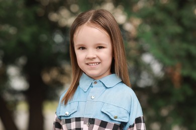 Photo of Portrait of happy little girl outdoors. Cute child