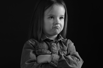 Photo of Portrait of sad girl on dark background, closeup. Black and white effect