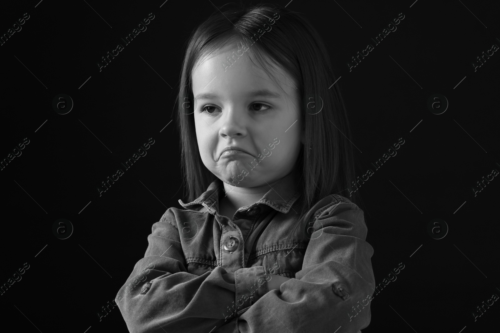 Photo of Portrait of sad girl on dark background, closeup. Black and white effect