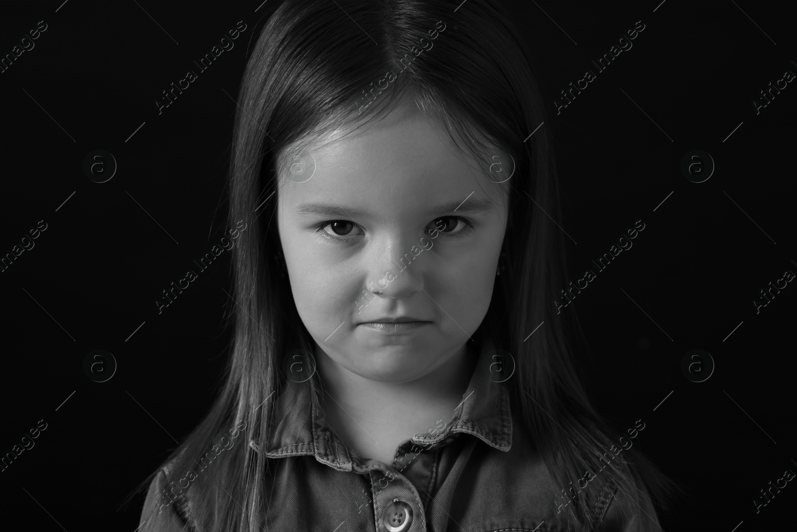 Photo of Portrait of sad girl on dark background, closeup. Black and white effect