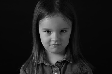 Photo of Portrait of sad girl on dark background, closeup. Black and white effect