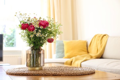 Photo of Beautiful ranunculus flowers and chamomiles in vase on table indoors. Space for text