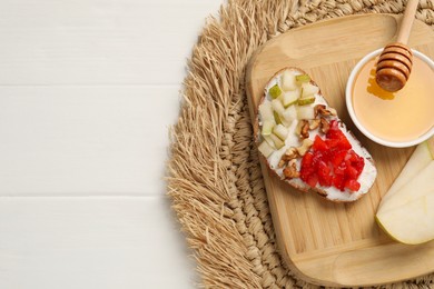 Delicious ricotta bruschetta with pear, strawberry and on white wooden table, top view. Space for text