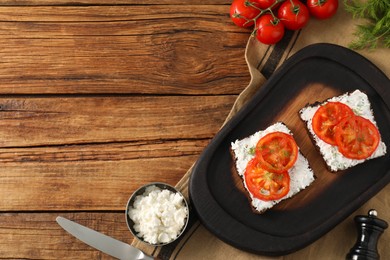 Photo of Delicious ricotta bruschettas with sliced tomatoes and dill on wooden table, flat lay. Space for text