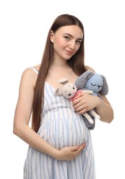 Photo of Expecting twins. Pregnant woman holding two toys on white background