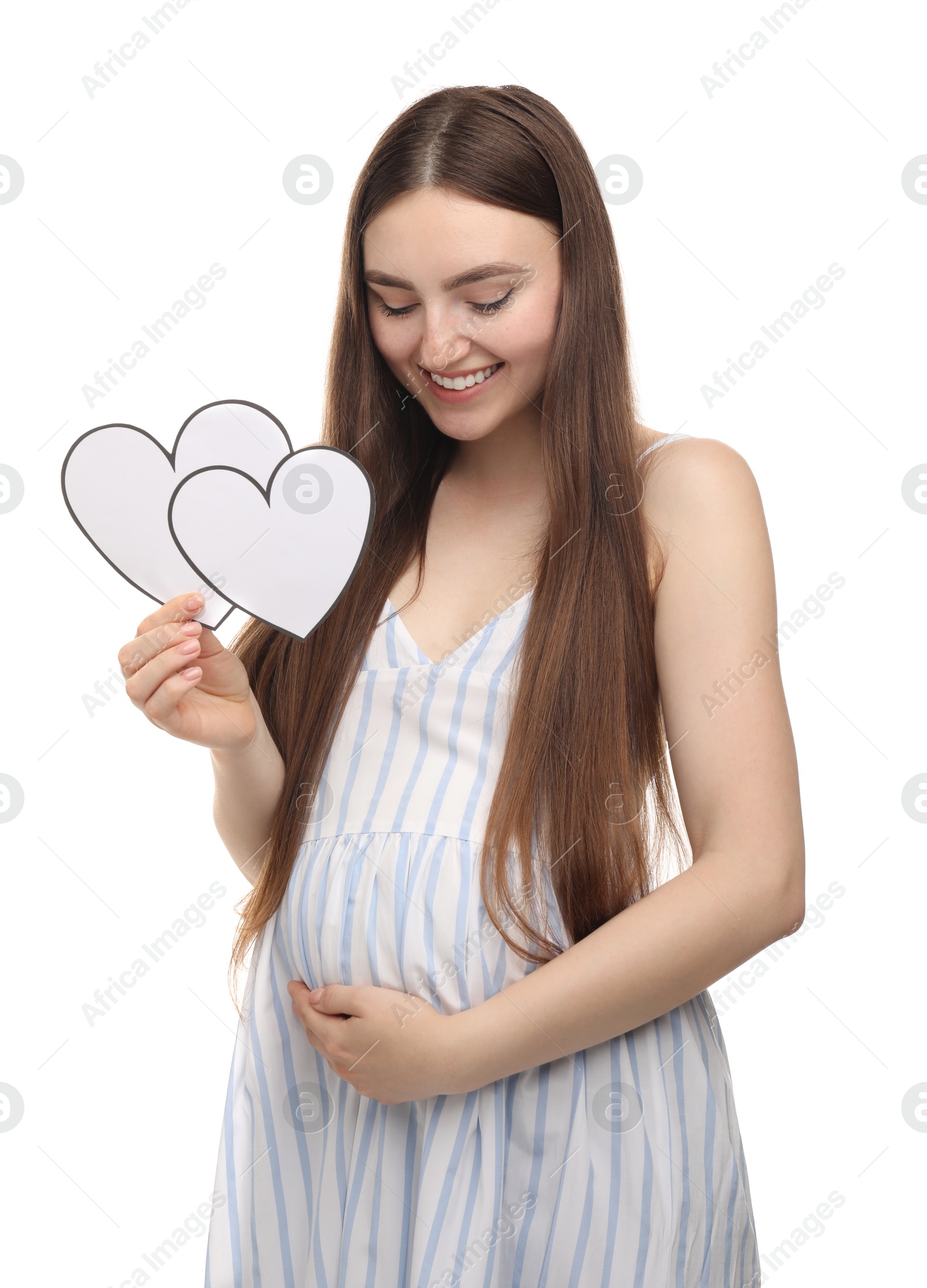 Photo of Expecting twins. Pregnant woman holding two paper cutouts of hearts on white background