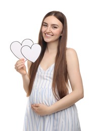 Photo of Expecting twins. Pregnant woman holding two paper cutouts of hearts on white background
