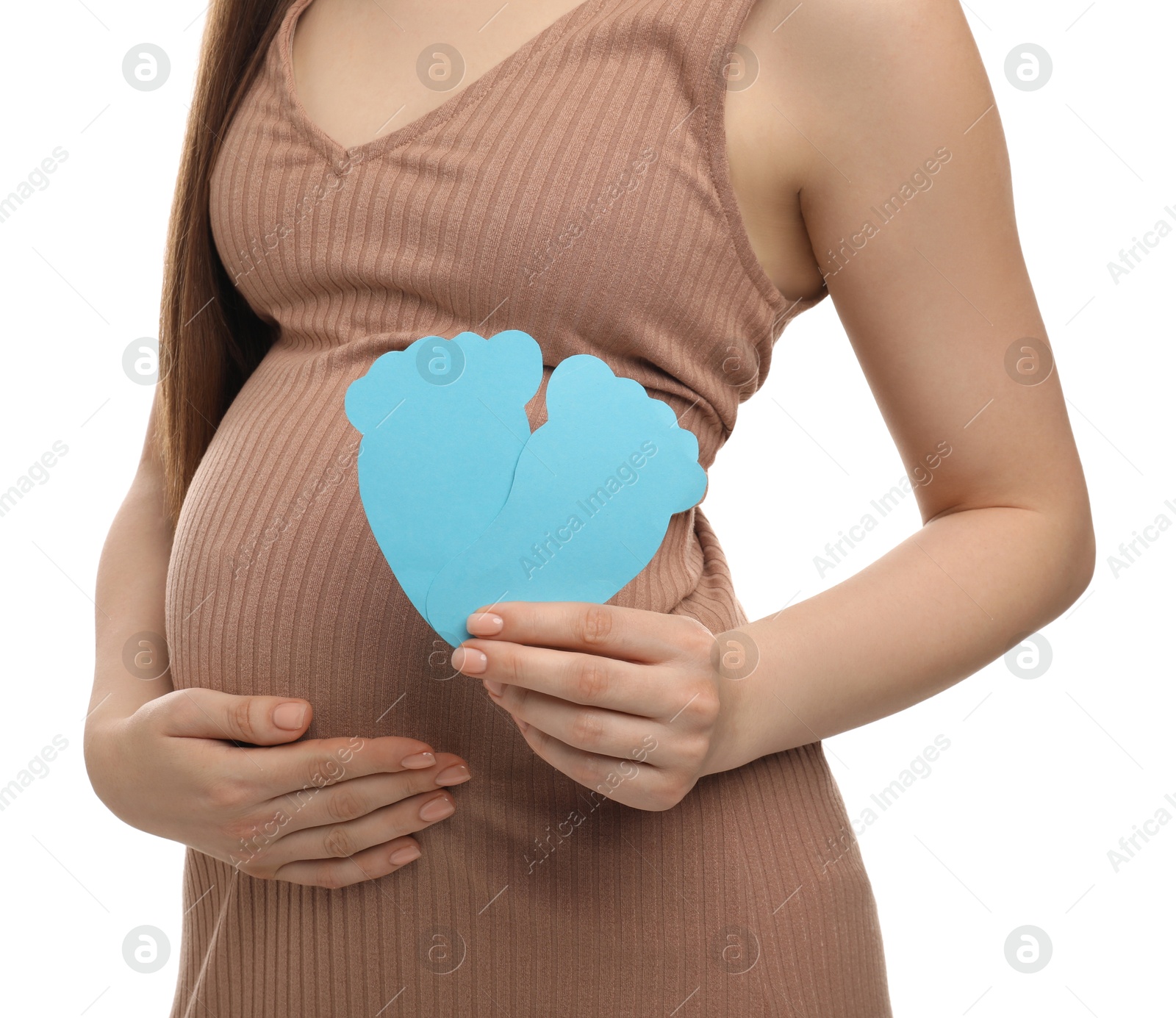 Photo of Expecting twins. Pregnant woman holding two paper cutouts of feet on white background, closeup