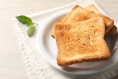 Delicious toasts served on wooden table, closeup