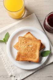 Delicious toasts served on wooden table, flat lay