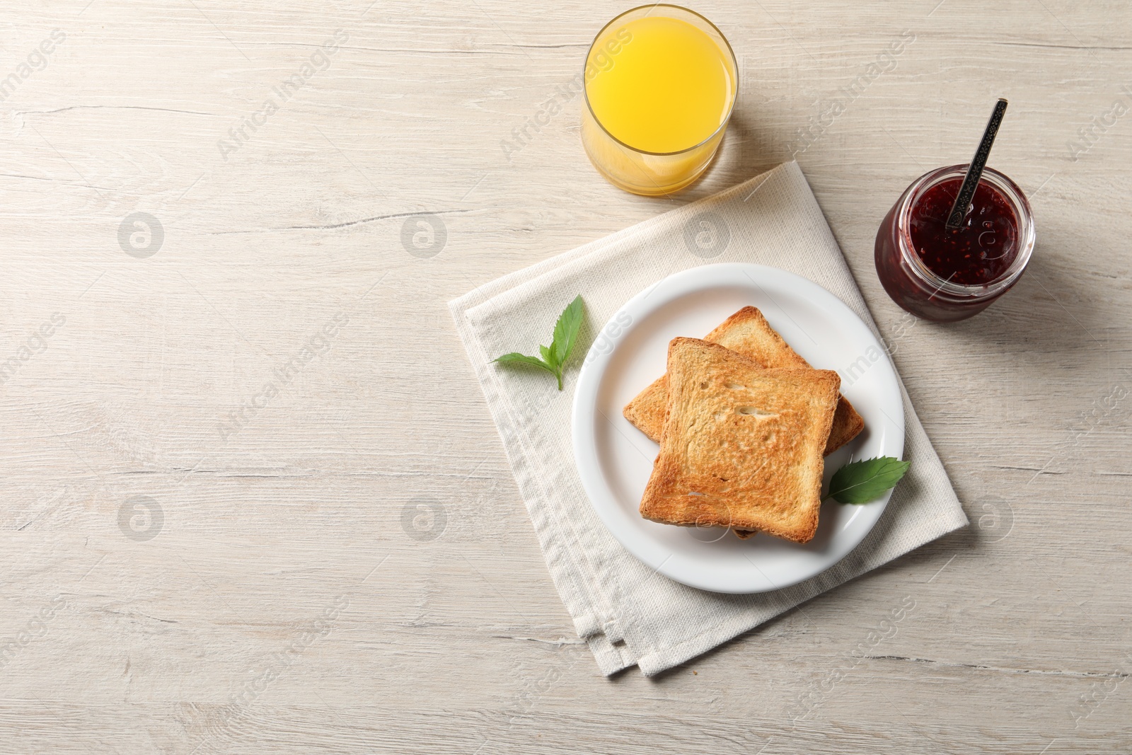 Photo of Delicious toasts served on wooden table, flat lay. Space for text