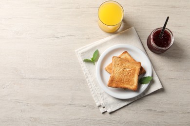 Delicious toasts served on wooden table, flat lay. Space for text