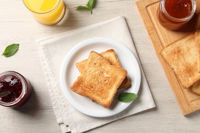 Delicious toasts served on wooden table, flat lay