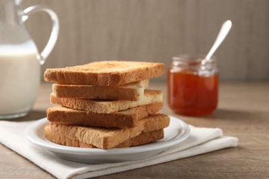 Photo of Slices of delicious toasted bread served on wooden table